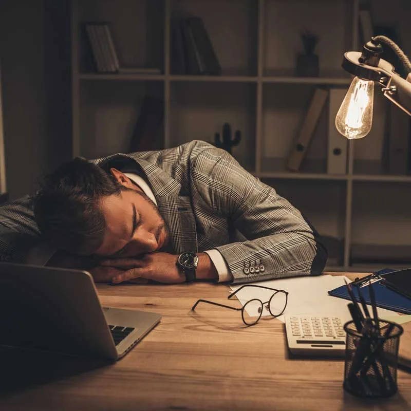 businessman sleeping on desk